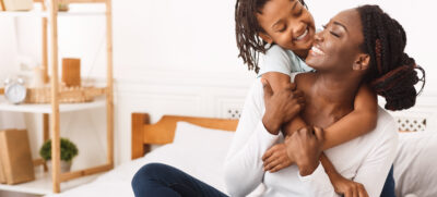 Togetherness,Concept.,African,Daughter,Hugging,Her,Mum,From,The,Back,