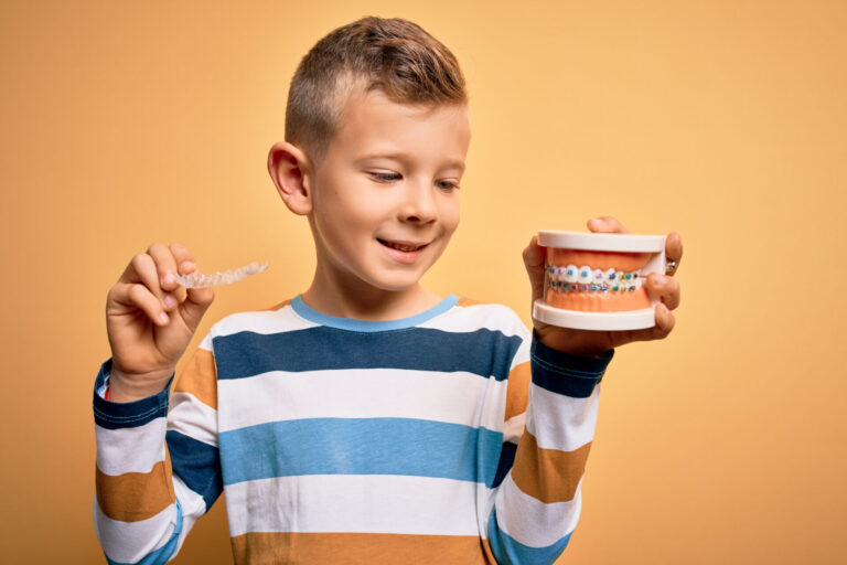 Little,Kid,Boy,Holding,Professional,Orthodontic,Denture,With,Metal,Braces