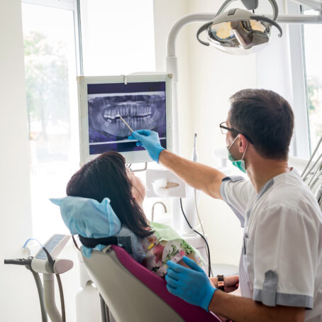 Orthodontist showing patient's teeth on X-ray